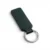 A dark green, blank premium leather keyholder before customisation, showcasing the raw stitching and thick leather grain on a wooden workshop table by WIKXY.