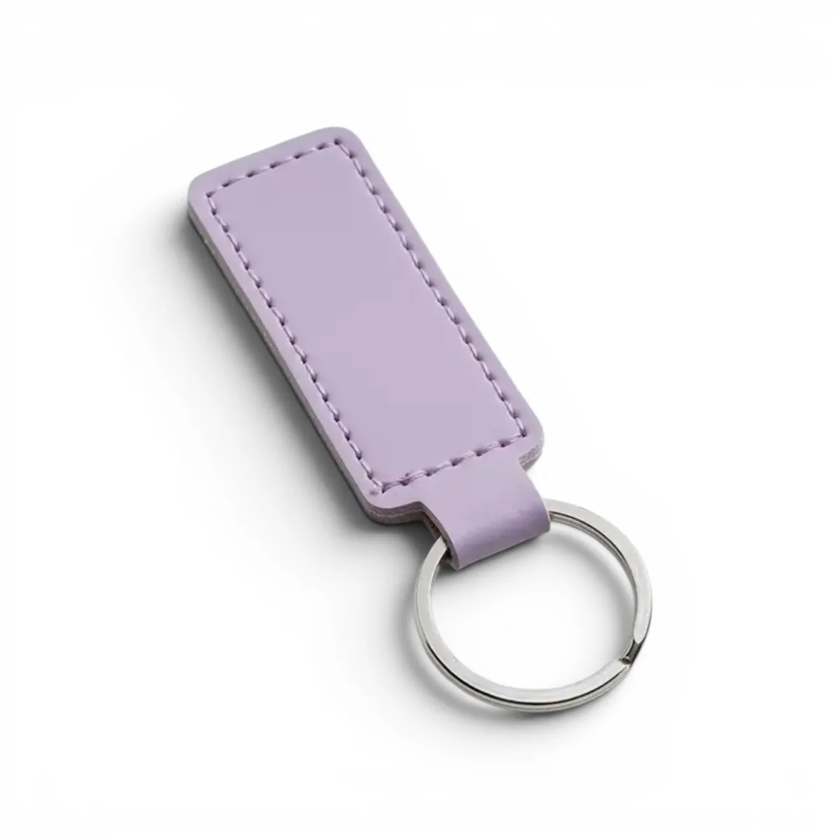 A rectangular lilac leather keyholder, precision engraved with custom text by WIKXY.