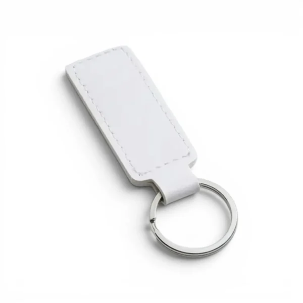 A white, blank premium leather keyholder before customisation, showcasing the raw stitching and thick leather grain on a wooden workshop table by WIKXY.
