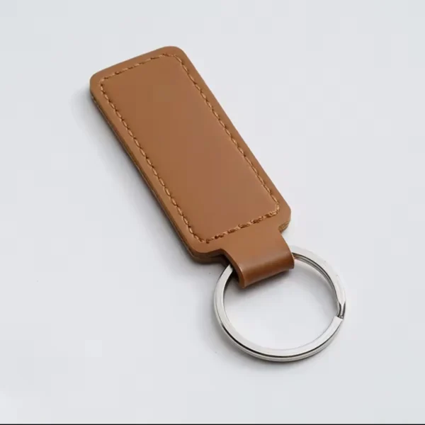 coffee-brown-laser-engraved-leather-keyholder-rectangular-shape Brown leather keyring with a stitched rectangular fob and silver metal ring