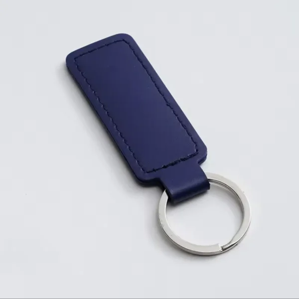 laser-engraved-leather-keyholder-rectangular-shape-dark-blue Dark Blue leather keyring with a silver metal ring on a white background